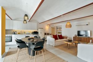 a kitchen and living room with a table and chairs at Amber and Rust Estremoz City House in Estremoz