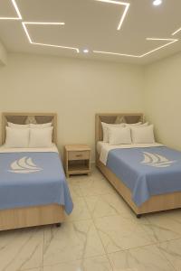 Giường trong phòng chung tại Relax in Style at Porto Said ,Chalets +79 ảnh