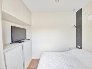 a bedroom with a bed and a tv on a shelf at Complejo Paso de los Andes in Rivadavia