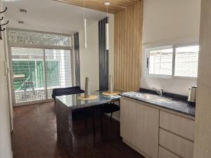 a kitchen with a counter with a sink and a counter top at Complejo Paso de los Andes in Rivadavia