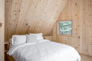 ein Schlafzimmer mit einem weißen Bett in einer Holzwand in der Unterkunft The Gale in Rawdon + 35 Fotos