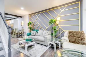 a living room with two couches and a table at Newly Renovated Abode with Patio in Baltimore! in Baltimore