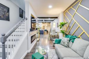 a living room with a couch and a table at Newly Renovated Abode with Patio in Baltimore! in Baltimore