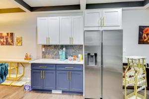 a kitchen with blue cabinets and a stainless steel refrigerator at Newly Renovated Abode with Patio in Baltimore! in Baltimore