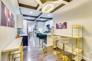 a kitchen with yellow and blue bar stools at Newly Renovated Abode with Patio in Baltimore! in Baltimore