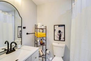 a bathroom with a toilet and a sink and a mirror at Newly Renovated Abode with Patio in Baltimore! in Baltimore +22 photos
