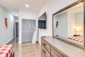 a bedroom with a large mirror and a dresser at Newly Renovated Abode with Patio in Baltimore! in Baltimore
