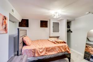 a bedroom with a bed in a room with white walls at Newly Renovated Abode with Patio in Baltimore! in Baltimore