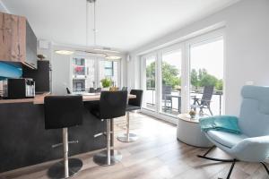 a kitchen and living room with a table and chairs at Lucia in Scharbeutz