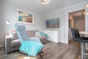 a living room with a couch and a table at Lucia in Scharbeutz