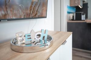a metal sign on a table in a kitchen at Lucia in Scharbeutz