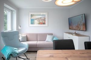 a living room with a couch and a table at Lucia in Scharbeutz +15 photos
