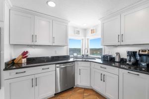 a white kitchen with white cabinets and a window at New 5 Bedrooms 3 full and 2 1 2 Bathroom Oceanfro in Ponte Vedra Beach +40 photos