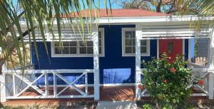 a blue and white house with a red door at Blue Serenity in Georgetown