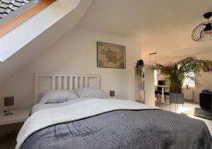 a bedroom with a large bed and a staircase at Ferienwohnung Sonnenblick in Detmold