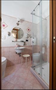 a bathroom with a shower and a sink and a toilet at Sancta Scala in Rome