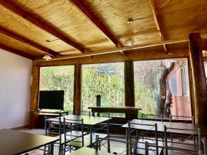 a room with tables and chairs and a large window at turisolcor atacama in San Pedro de Atacama +21 photos