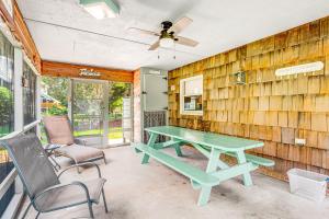 a patio with a green picnic table and chairs at Kent Condo - 39260 Retreat in Bethany Beach