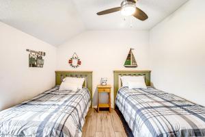two beds in a room with a ceiling fan at Kent Condo - 39260 Retreat in Bethany Beach