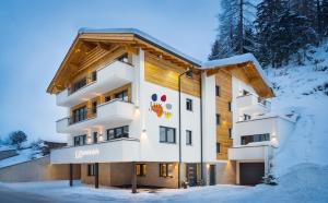 a building in the winter with snow on the ground at Lux Appartements in Ischgl