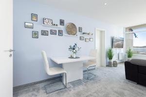 a white office with a desk and a couch at Aloha Suite in Fehmarn