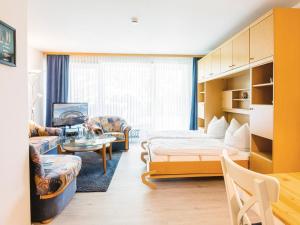 a living room with a bed and a table at Waldstraße 2 Ferienwohnung Volkenborn in Kellenhusen