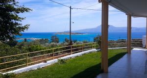 a view of the ocean from the porch of a house at Marathi Panorama Rooms in Marathi