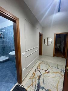 a bathroom with a shower and a sink at Turdiu center apart in Tirana +9 photos