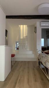 a room with a bed and a living room with a table at ROSALINDA - Borgo Experience Cilento in Casaletto Spartano