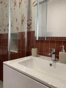 a bathroom with a white sink and a mirror at ROSALINDA - Borgo Experience Cilento in Casaletto Spartano