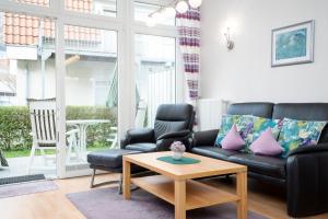 a living room with a couch and a coffee table at Villa Olga Wohnung 3 in Grömitz +24 photos