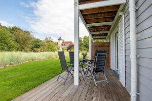 a porch with a table and chairs on it at Wohnung 2 in Haffkrug