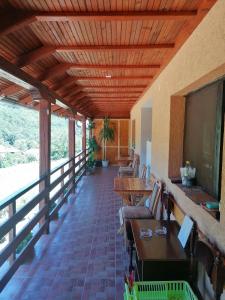 a covered porch with chairs and a projection screen at Sobe i apartmani Simic in Ribarska Banja