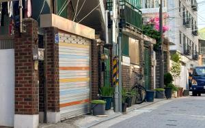 a building with two garage doors on the side of a street at Ahn-sik, 安息 in Seoul