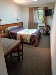 Postel nebo postele na pokoji v ubytování Hotel Menfis + 2 fotografie