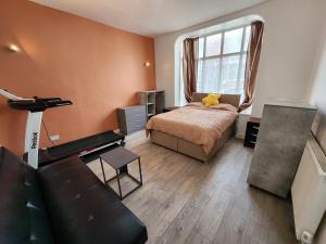 una camera da letto con un letto, un divano e una finestra di Newly Refurbished 3 Bedroom House with Lovely Garden a Bolton Altre 21 foto
