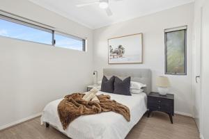 パースにあるTranquil Tree Views 2 Bedroom 2 Bathroom Apartmentの毛布がかけられたベッドのある寝室