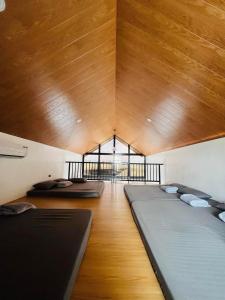 a room with three beds in it with a wooden ceiling at Josh cabins in Bacolor +16 photos