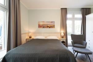 Ένα ή περισσότερα κρεβάτια σε δωμάτιο στο Strandresidenz Vogelflug Sundperle