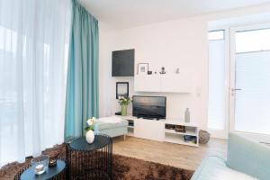 TV a/nebo společenská místnost v ubytování KellenHus Wohnung 3