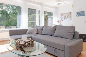 a living room with a couch and a glass table at Panoramic NiNis Mupfel in Hansaland +42 photos