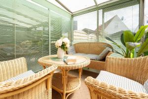 a room with a table and chairs on a balcony at Lange Wiese 16b in Dahme +37 photos