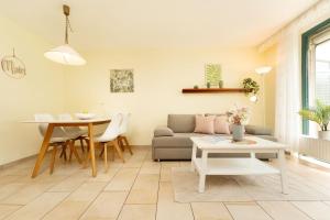 a living room with a couch and a table at Lange Wiese 16b in Dahme