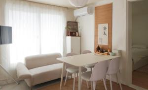 a dining room with a white table and chairs at Ahn-sik, 安息 in Seoul