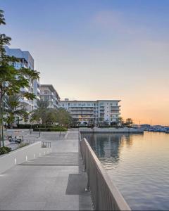 a large building next to a body of water at Brand new apartmentWith a nice view balcony in Seeb +23 photos