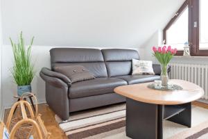 a living room with a couch and a table at Haus Hüttmann Sommerbrise in Gremsmühlen