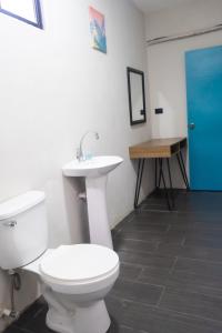 a bathroom with a toilet and a sink at REEF ON THE WATER in Tamanique +18 photos