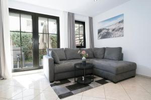 a living room with a couch and a table at Haus Titania Wohnung 2 in Grömitz