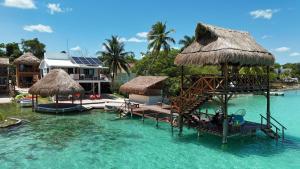 a resort in the water with chairs and umbrellas at Hotel Solana Bacalar Lakefront in Bacalar