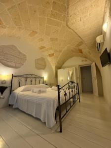 a bedroom with a bed in a room with a stone ceiling at Dimora 69 in Lecce +35 photos